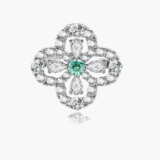 Sterling silver adjustable ring featuring four-leaf clover design with green center moissanite and clear accent stones