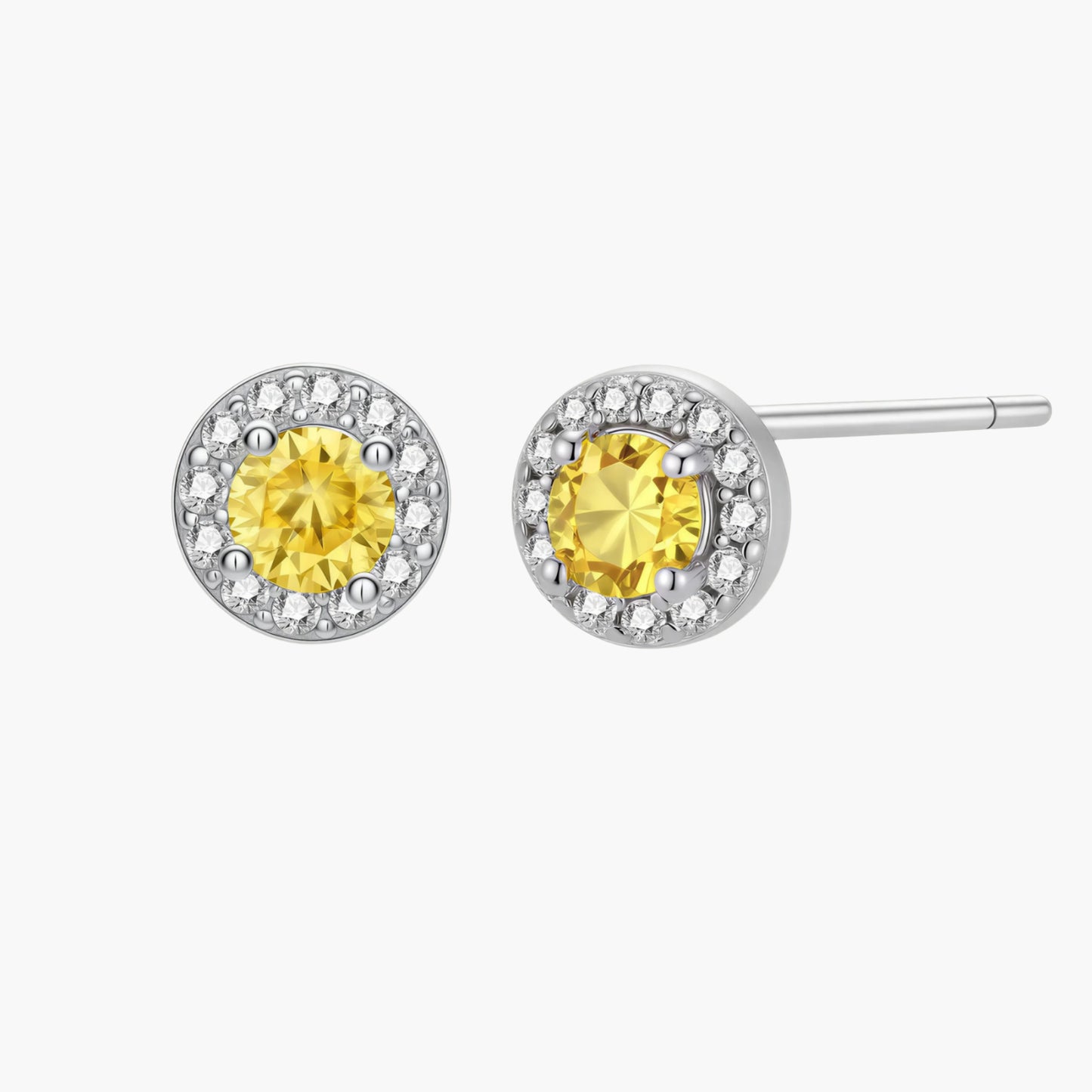 Dainty sterling silver stud earrings with yellow moissanite center stones surrounded by white halo stones