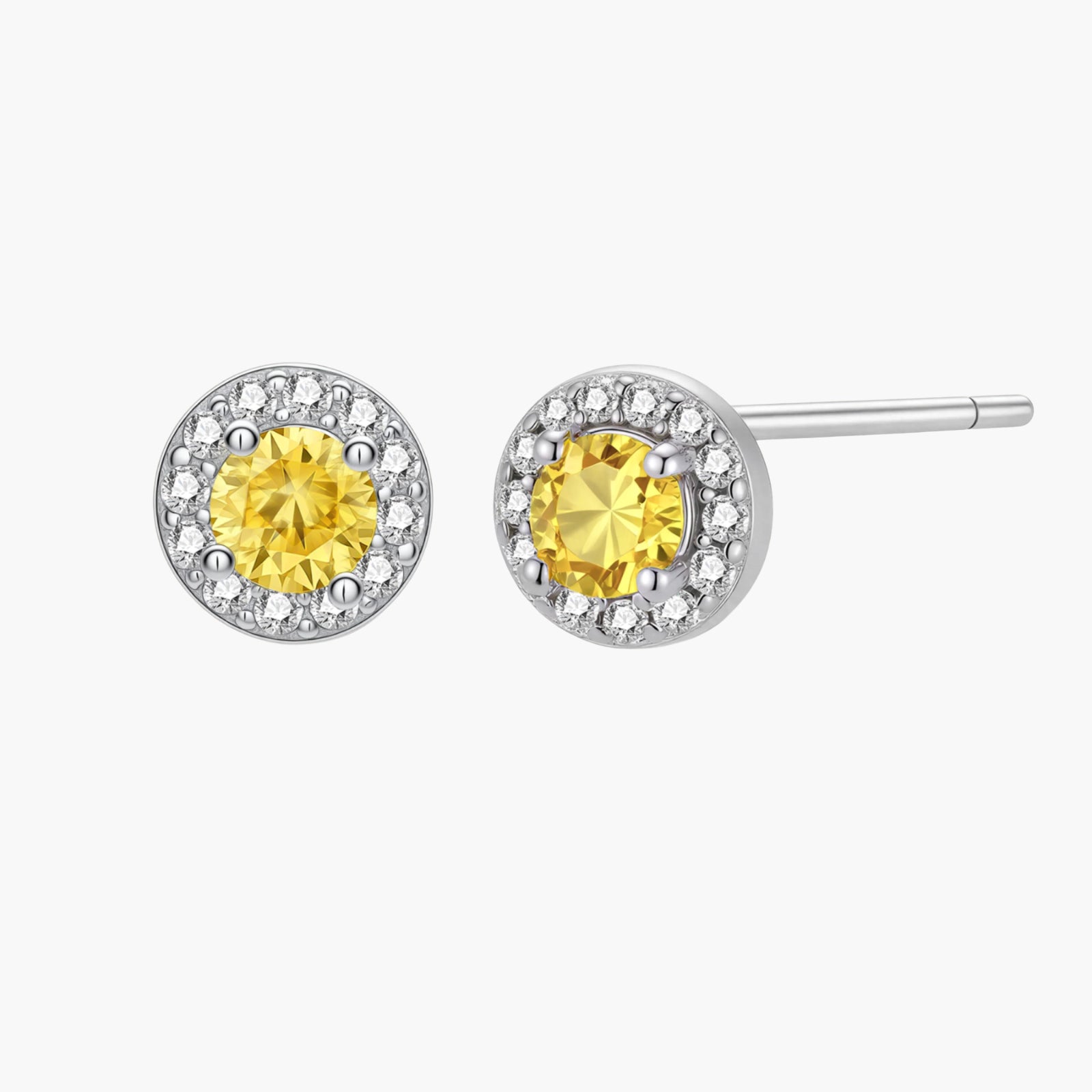 Dainty sterling silver stud earrings with yellow moissanite center stones surrounded by white halo stones