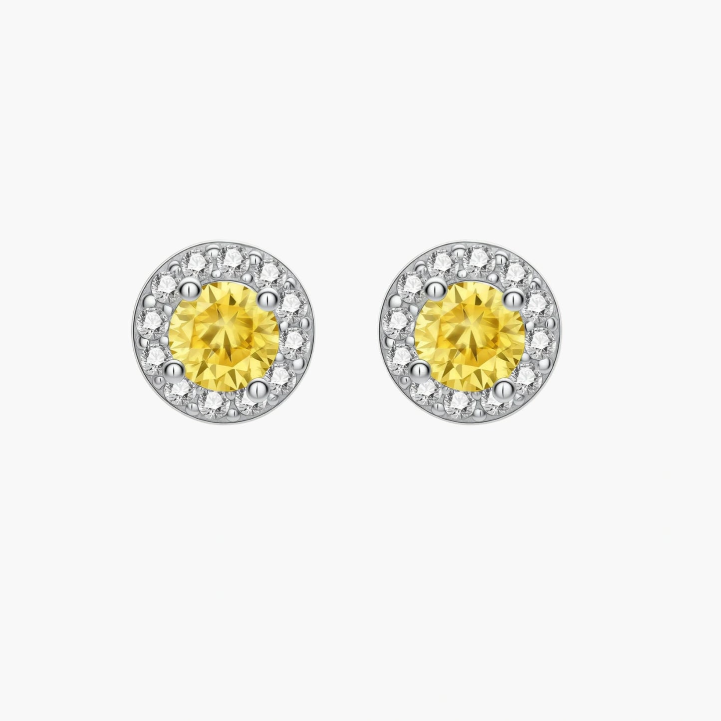 Dainty sterling silver stud earrings with yellow moissanite center stones surrounded by white halo stones