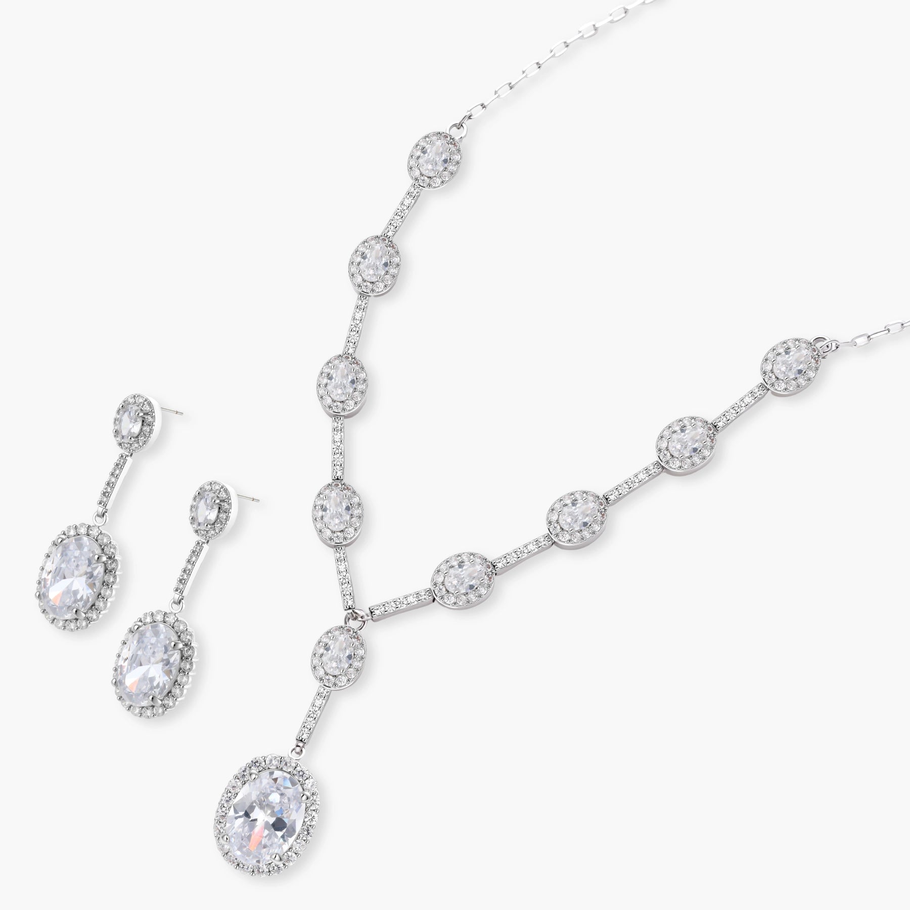 Elegant white gold plated jewelry set with oval cubic zirconia stones in halo settings, featuring Y-necklace and drop earrings.